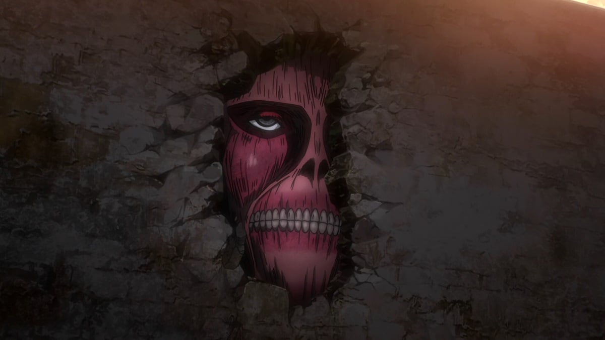 A crack in the Wall reveals the face of a Colossal Titan in 'Attack on Titan'.