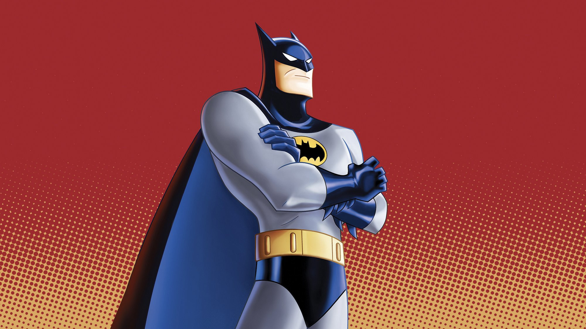 Batman stands with his arms crossed in front of a red background.