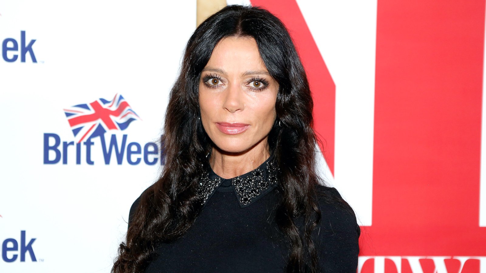 Carlton Gebbia from The Real Housewives of Beverly Hills is standing in front of a BritWeek sign.