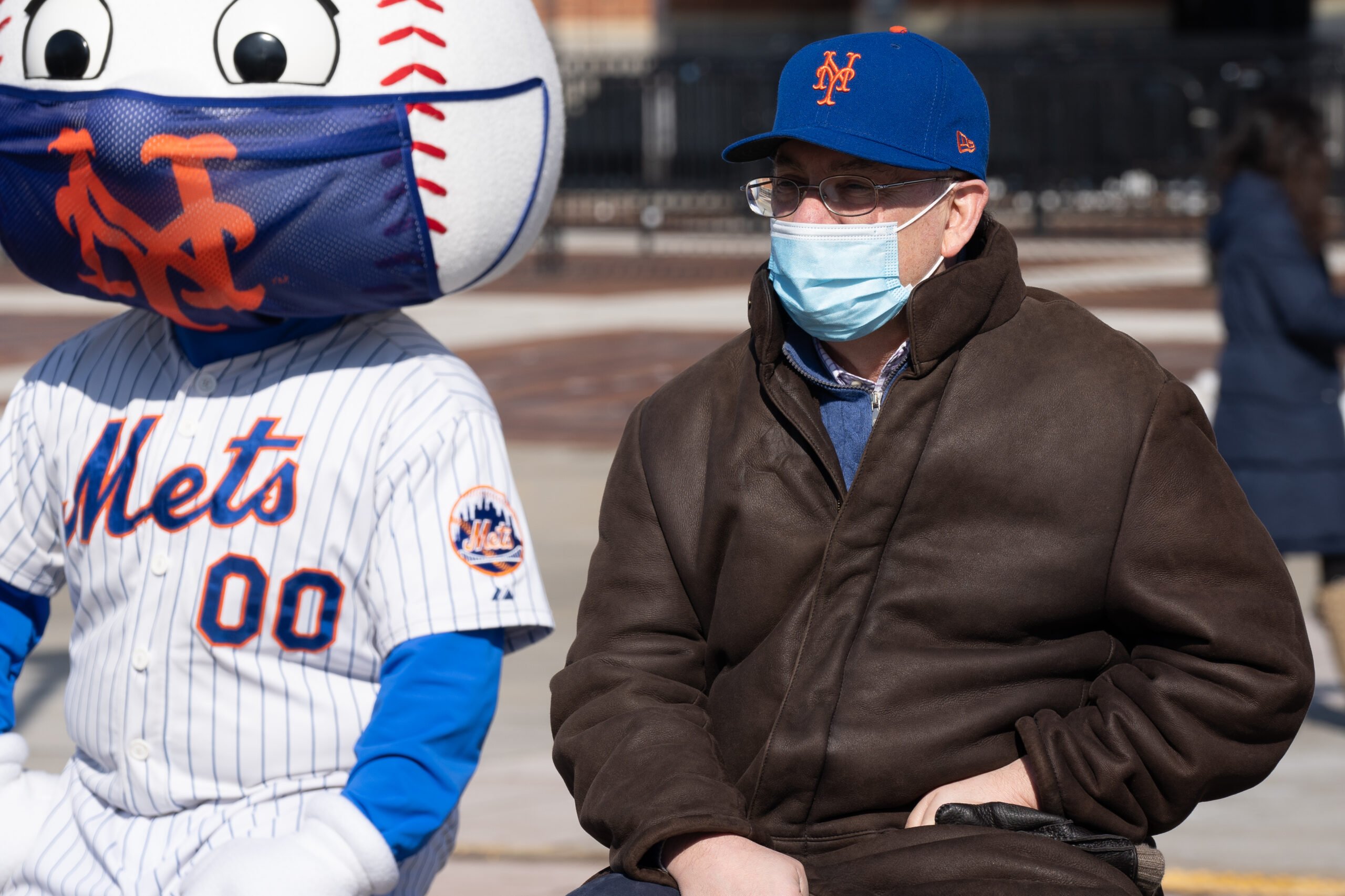 Steve Cohen, owner of the Mets, seated next to "Mr. Met", the team's legendary mascot.