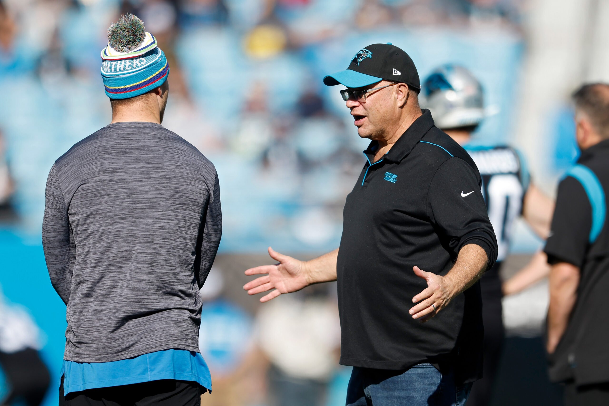Carolina Panthers owner David Tepper, out on the field with member of his football team