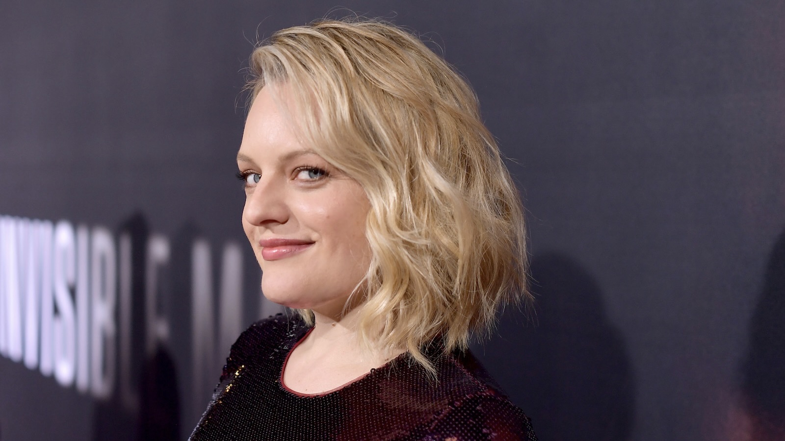 Semi-profile of Elizabeth Moss, smiling