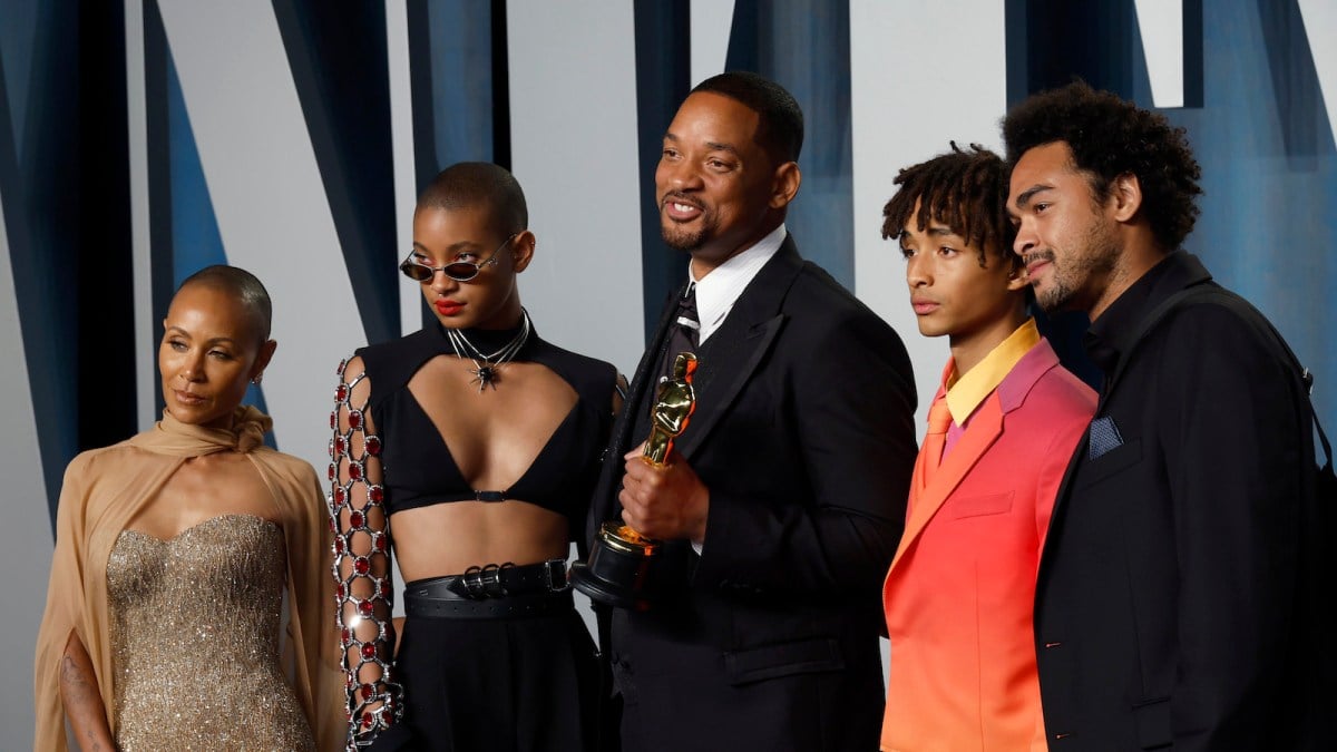 Will Smith holds Academy Award statue accompanied by wife Jada Pinkett and children Willow, Jaden, and Trey on the red carpet of the Vanity Fair Oscar party.