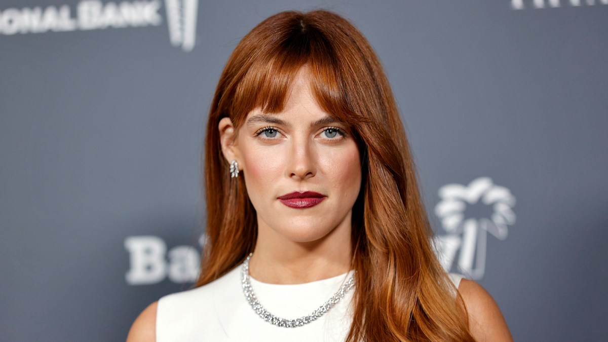 Riley Keough in a white dress and signature red hair