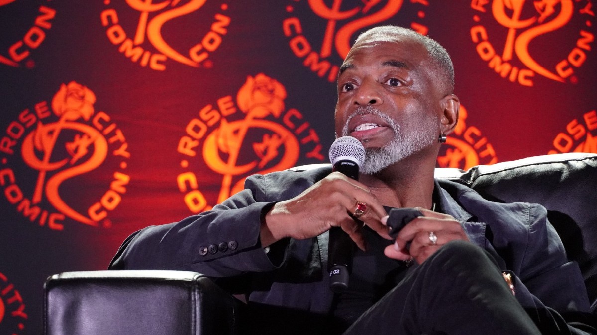 LeVar Burton holds a microphone during a fan Q&A.