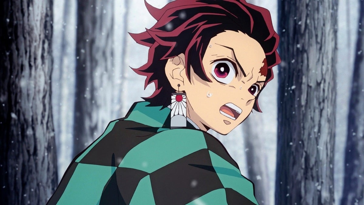 Tanjiro looking stressed in the middle of a fight in Demon Slayer.