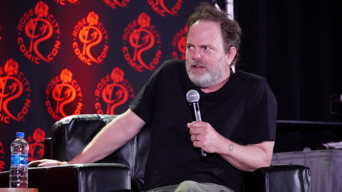 Rainn Wilson gives a talk at a fan event.