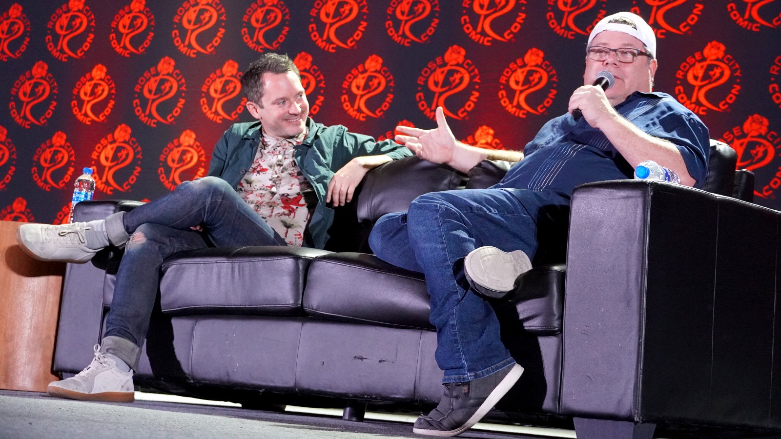 Sean Astin and Elijah Wood field questions from fans at a comic con event.