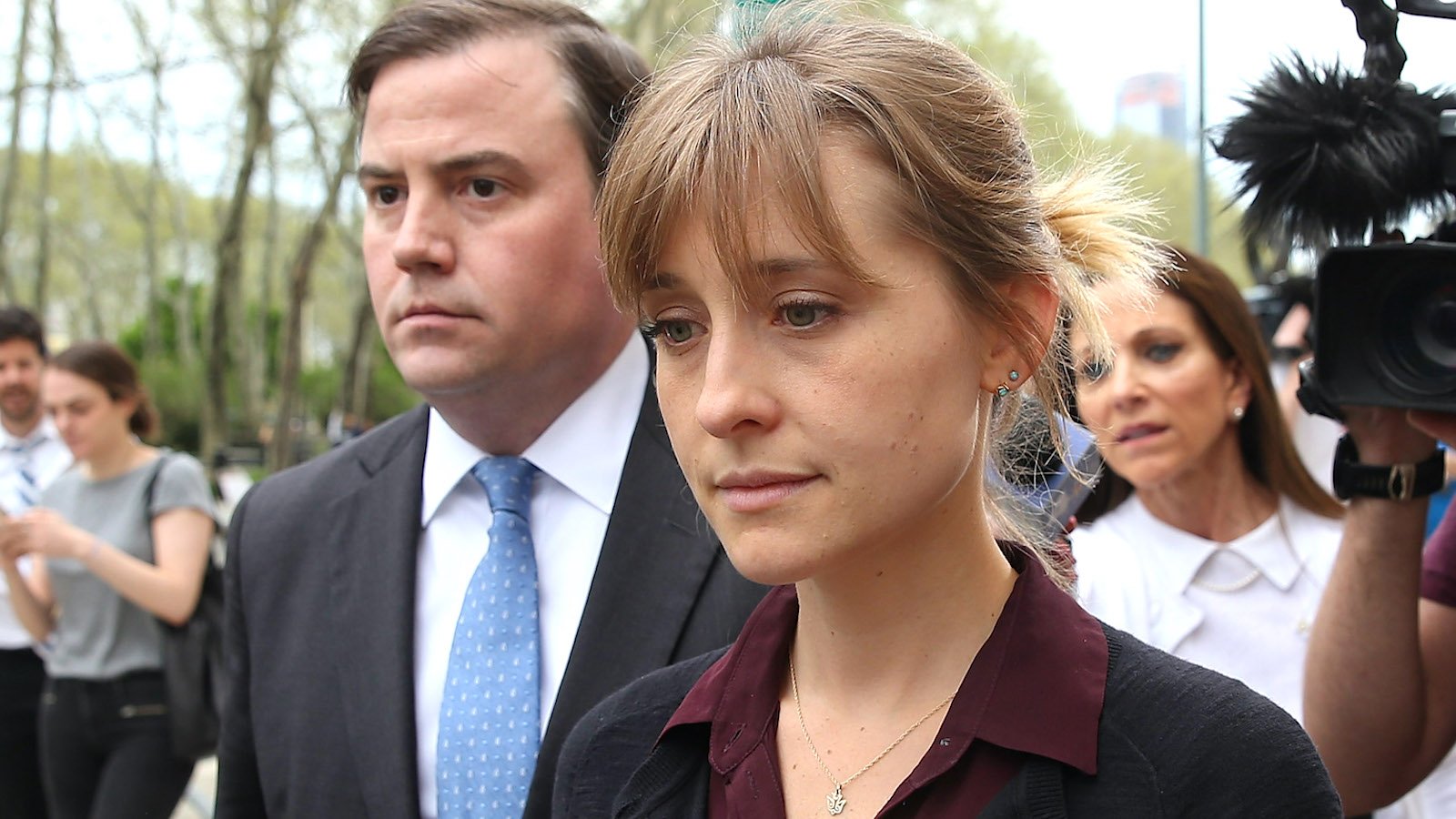 Allison Mack surrounded by reporters and cameras