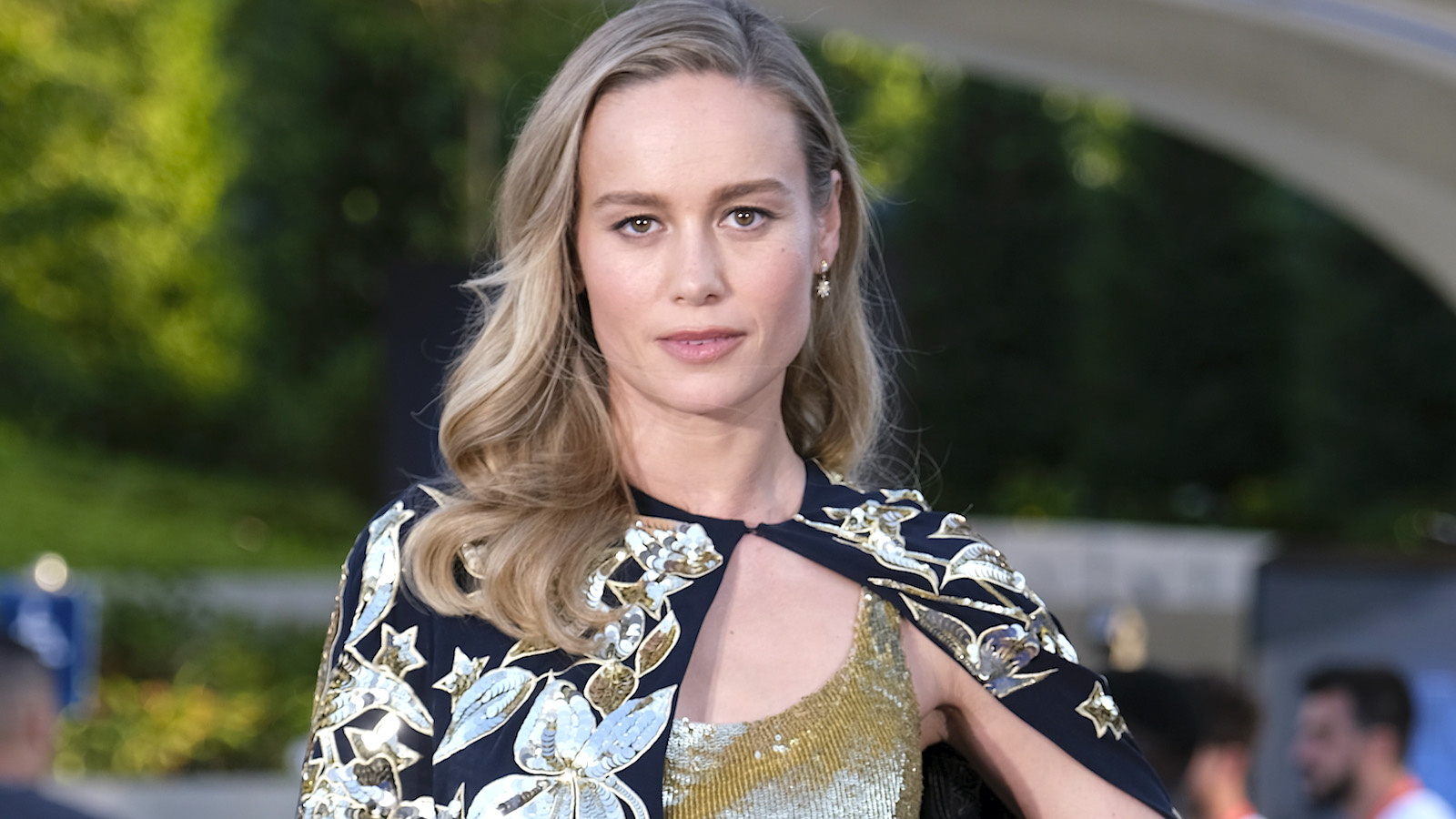 Brie Larson in a gold and black dress