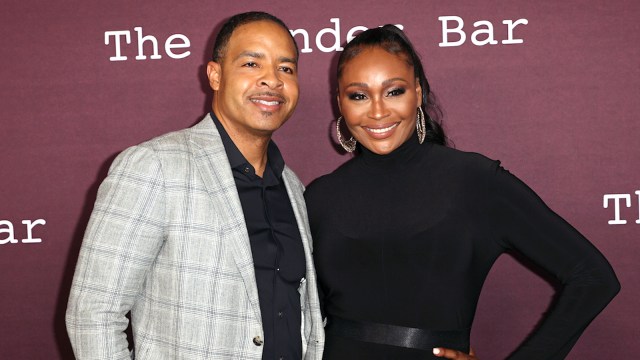 (L) Mike Hill in a checkered grey suit and (R) Cynthia Bailey in a turtleneck black dress