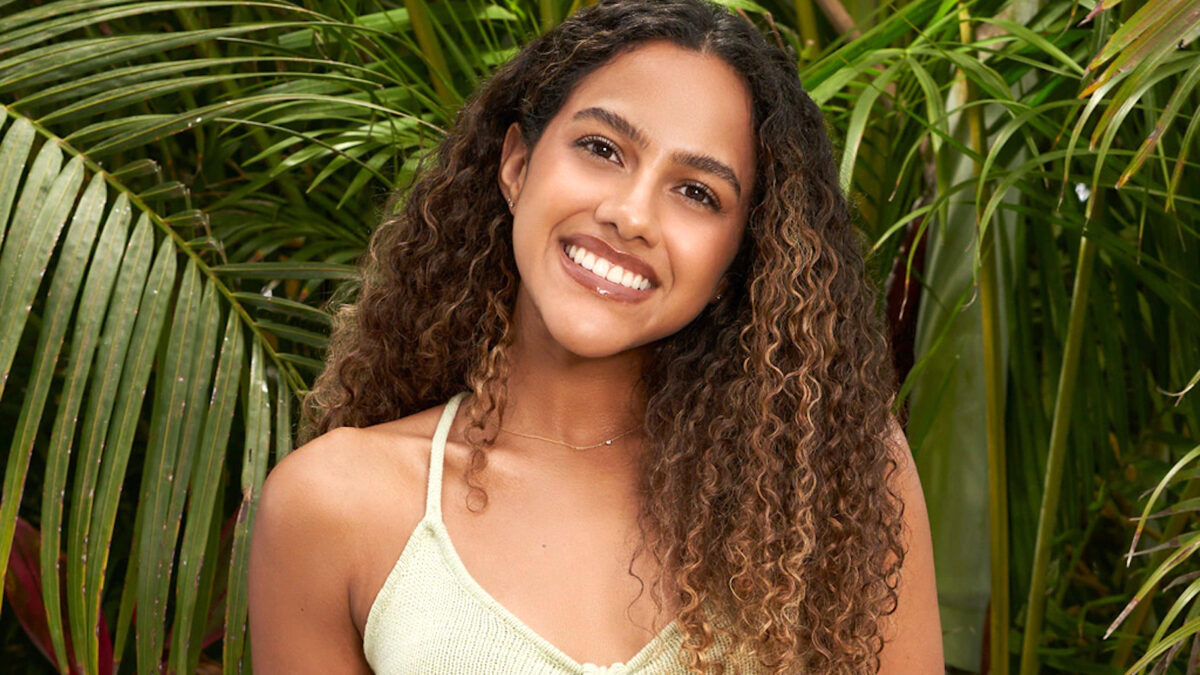 Teddi Wright smiling in a pale yellow bikini and sporting her naturally curly hair