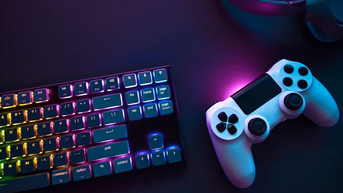 Top down view of colorful illuminated gaming accessories laying on table.