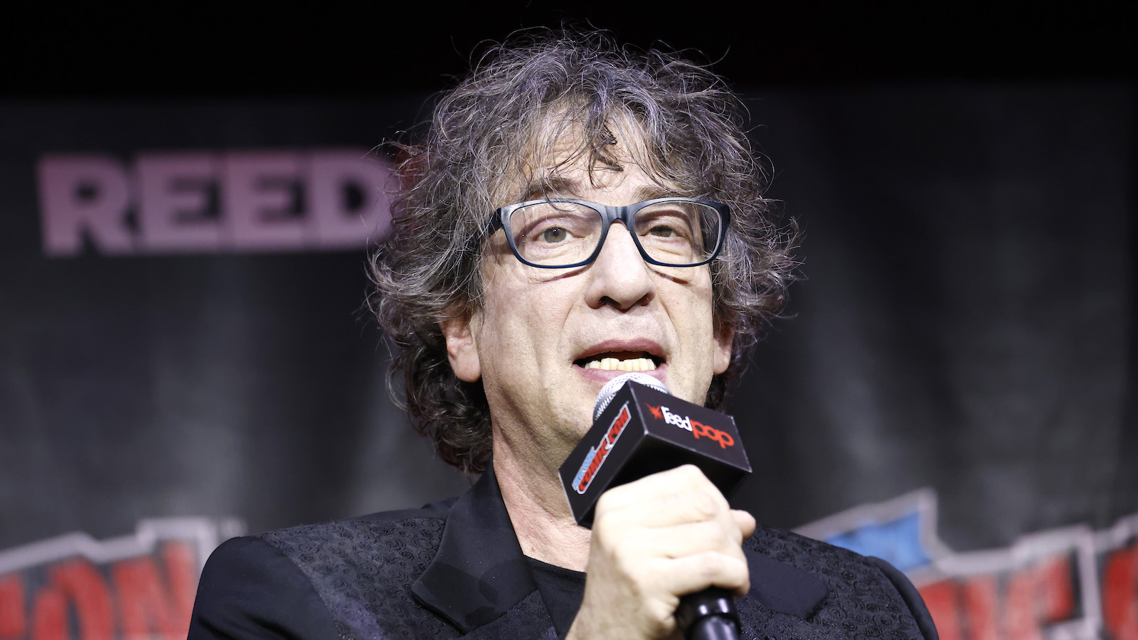 Neil Gaiman speaks onstage at the Prime Video Presents: Good Omens panel during New York Comic Con 2022 on October 07, 2022 in New York City.