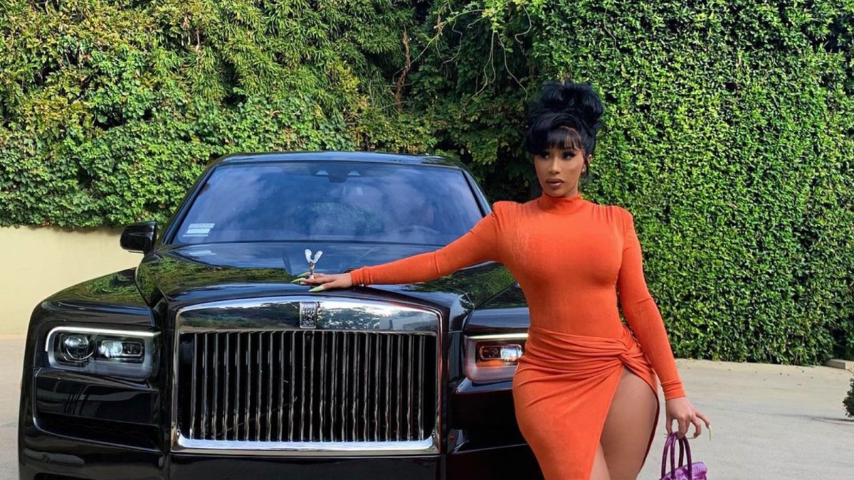 Cardi B next to her car