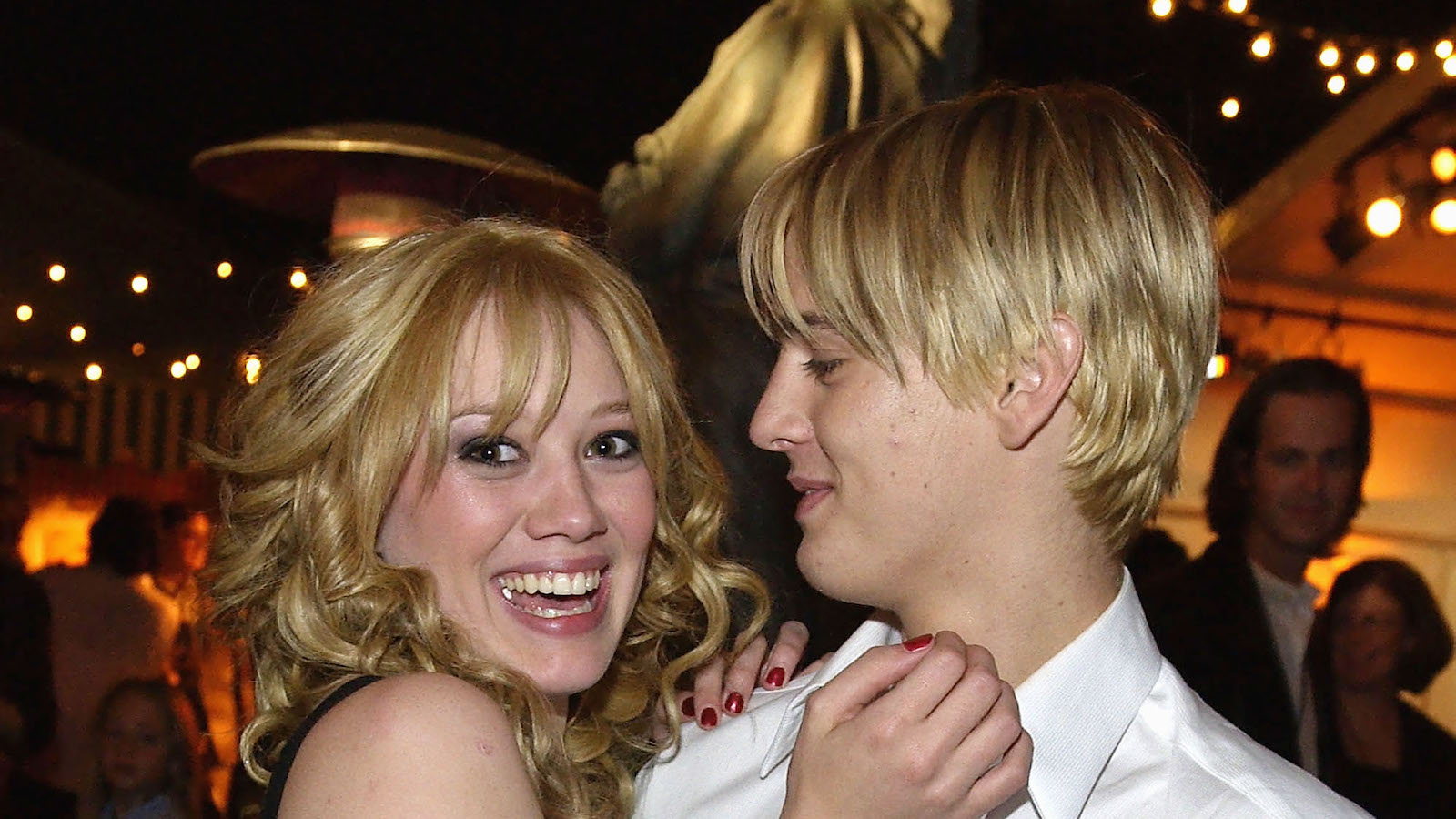 Actress Hilary Duff (L) hugs singer Aaron Carter at the post-premiere party for The Lizzie McGuire Movie on April 26, 2003 in Hollywood, California