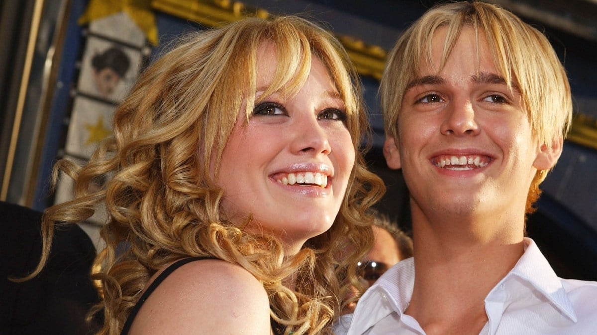 Hilary Duff and Aaron Carter strike a pose at a red carpet event.