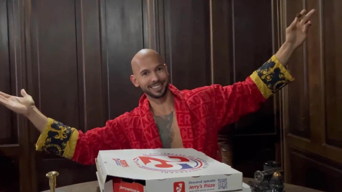 Andrew Tate posing with Jerry's Pizza boxes