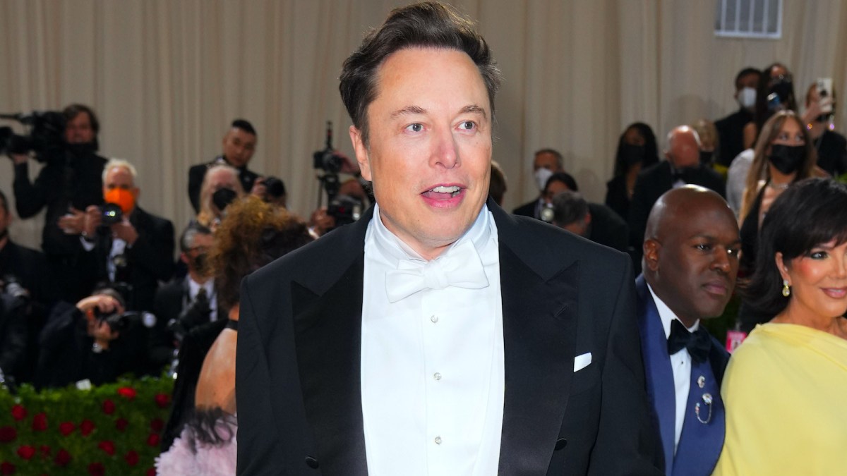 Elon Musk in a black and white suit on the red carpet of the Met Gala