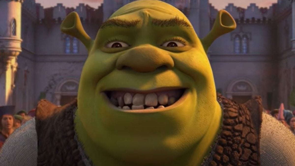 Shrek is smiling with his teeth showing. 