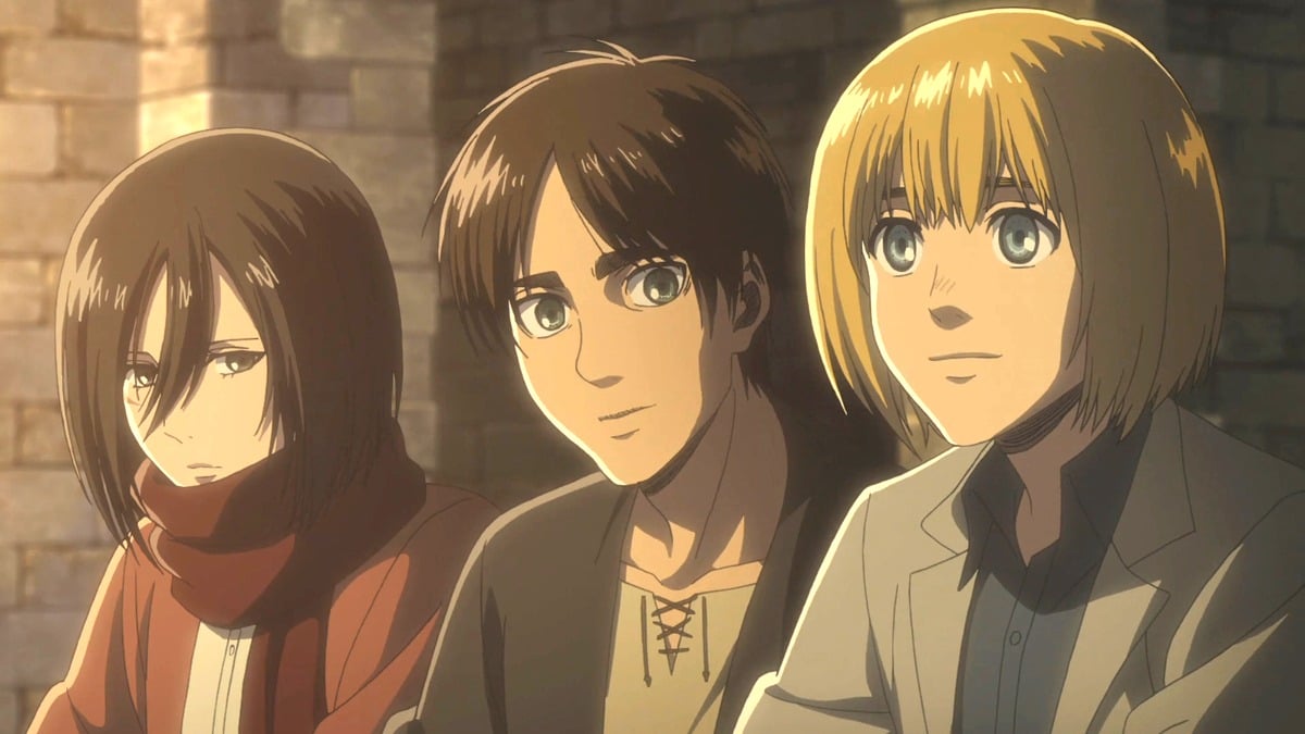 Mikasa Arckerman, Eren Jaeger, and Armin Arlert sitting together in 'Attack on Titan'