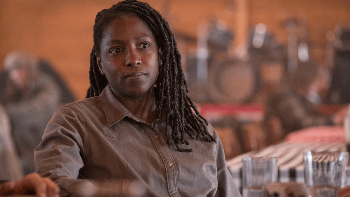 Maria (Rutina Wesley) sitting in the Jackson cafeteria