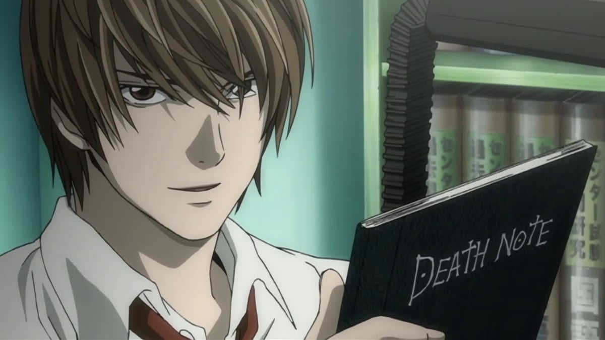 Light Yagami from 'Death Note' is holding up a book. 