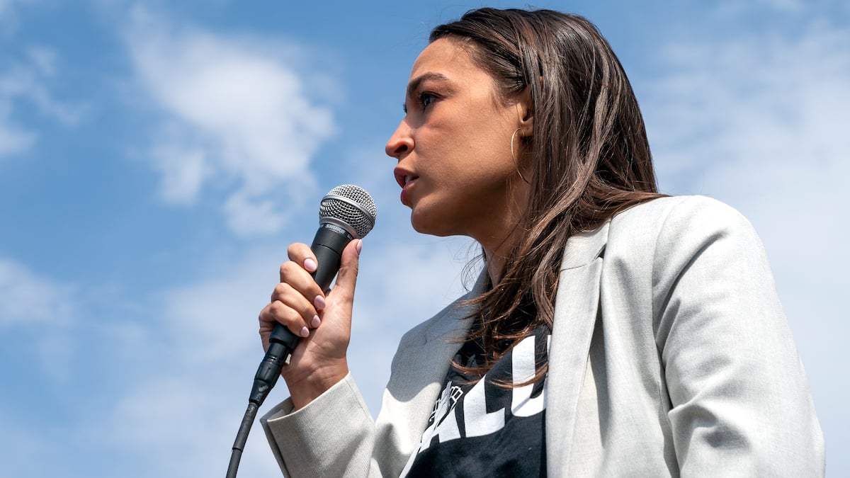 Representative Alexandria Ocasio-Cortez speaking into a microphone