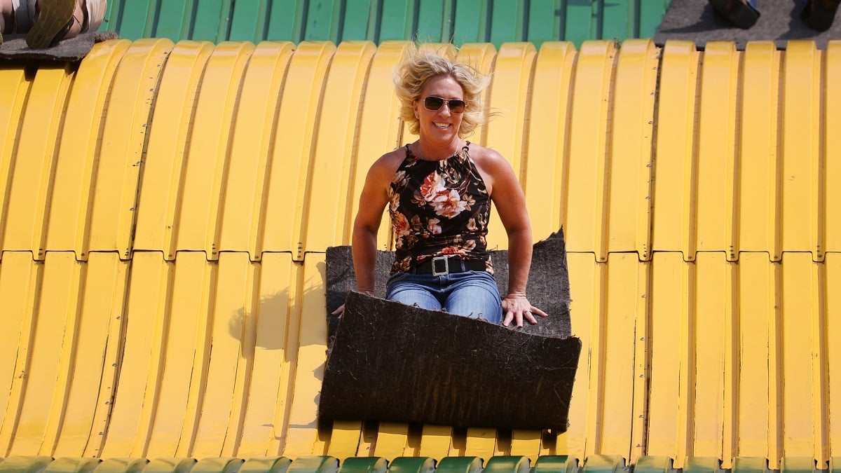 DES MOINES, IOWA - AUGUST 19: U.S. Rep. Marjorie Taylor Greene (R-GA) rides the giant slide during a visit to the Iowa State Fair on August 19, 2021 in Des Moines, Iowa. The fair is often used by politicians seeking to test the waters before jumping into a presidential race. Greene said, during her visit, that she supports former President Donald Trump for the 2024 Republican nomination.