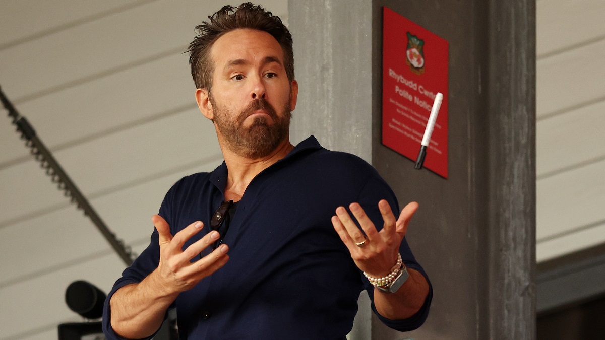 WREXHAM, WALES - APRIL 22: Ryan Reynolds, Owner of Wrexham catches a pen prior to the Vanarama National League match between Wrexham and Boreham Wood at Racecourse Ground on April 22, 2023 in Wrexham, Wales.