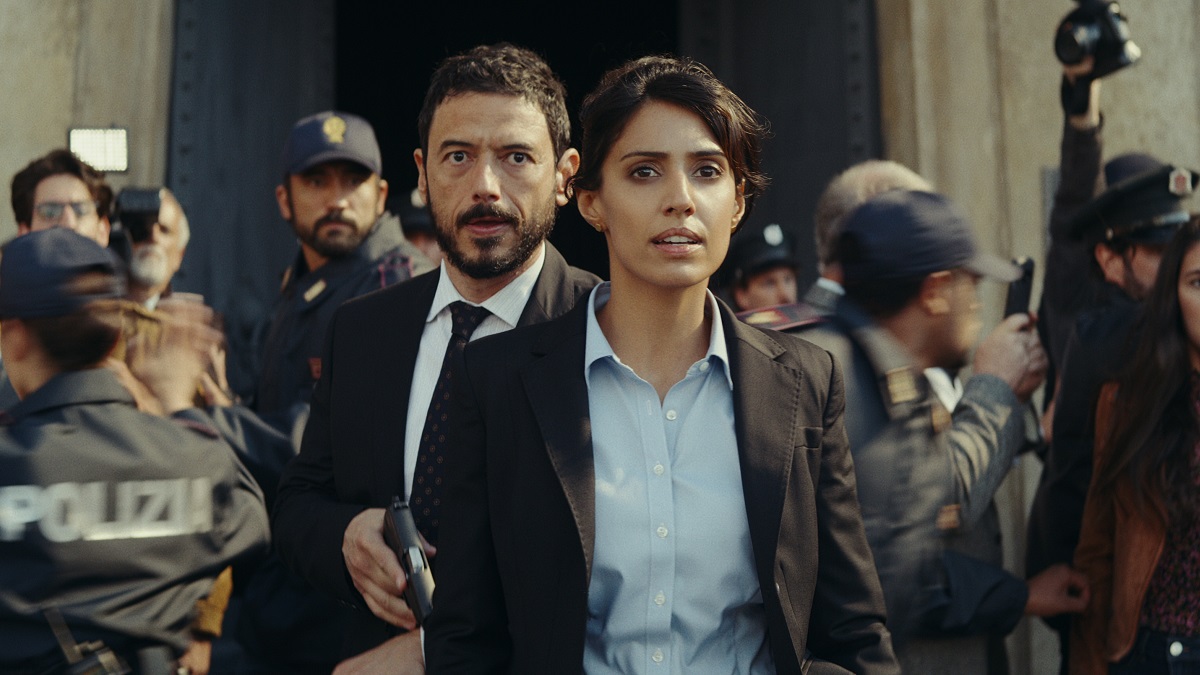 Red Notice. (L-R) Rafael Petardi as Security Chief Ricci and Ritu Arya as Inspector Urvashi Das in Red Notice.