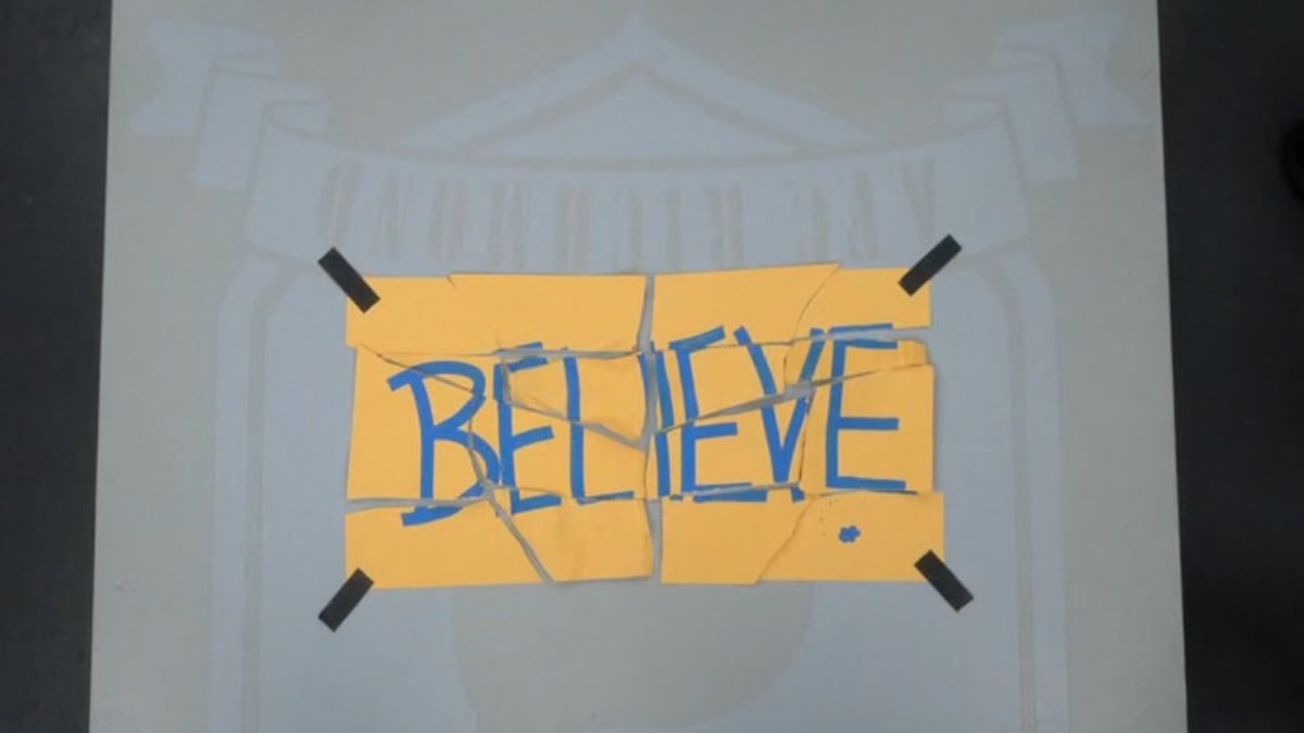 A torn up piece of paper that says "Believe" is shown. 