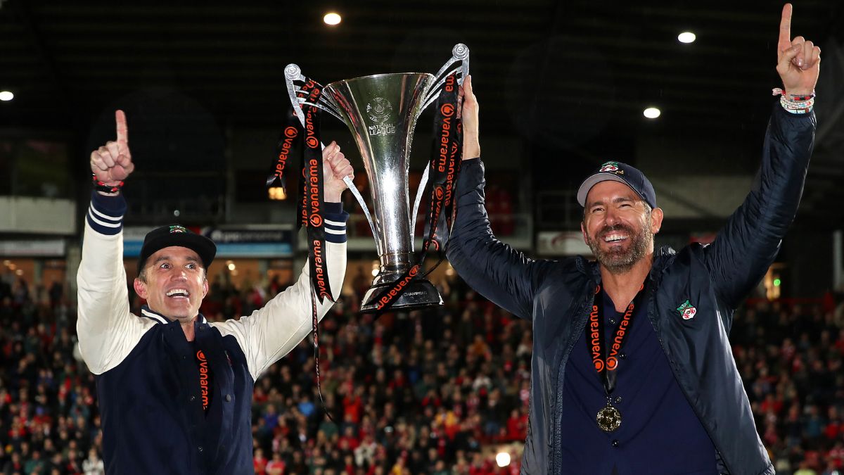 WREXHAM, WALES - APRIL 22: Rob McElhenney and Ryan Reynolds, Owners of Wrexham celebrate with the Vanarama National League trophy as Wrexham win the Vanarama National League and are promoted to the English Football League after victory in the Vanarama National League match between Wrexham and Boreham Wood at Racecourse Ground on April 22, 2023 in Wrexham, Wales.