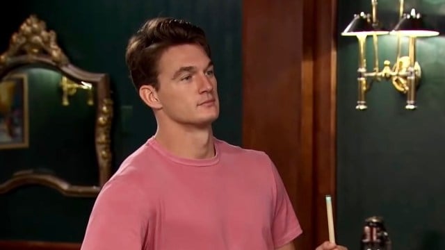 The Bachelorette star Tyler Cameron holding a cue stick