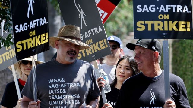 Striking SAG-AFTRA members picket with striking WGA (Writers Guild of America) workers outside Warner Bros. Studio on July 17, 2023 in Burbank, California. Members of SAG-AFTRA, Hollywood’s largest union which represents actors and other media professionals, have joined the striking writers in the first joint walkout against the studios since 1960. The strike could shut down Hollywood productions completely with writers in the third month of their strike against the Hollywood studios. (Photo by Mario Tama/Getty Images)