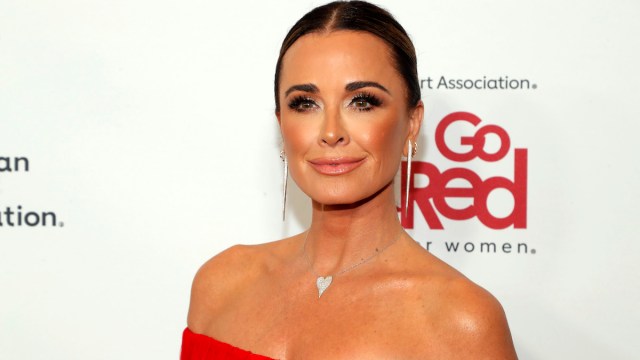 Kyle Richards wearing a strapless red dress attending The American Heart Association's Go Red for Women Red Dress Collection Concert 2023