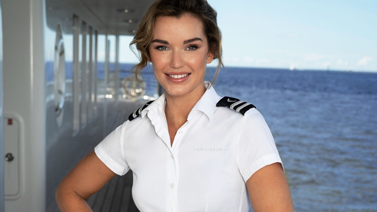 Jaimee Neale on deck in her uniform, standing in front of the sea