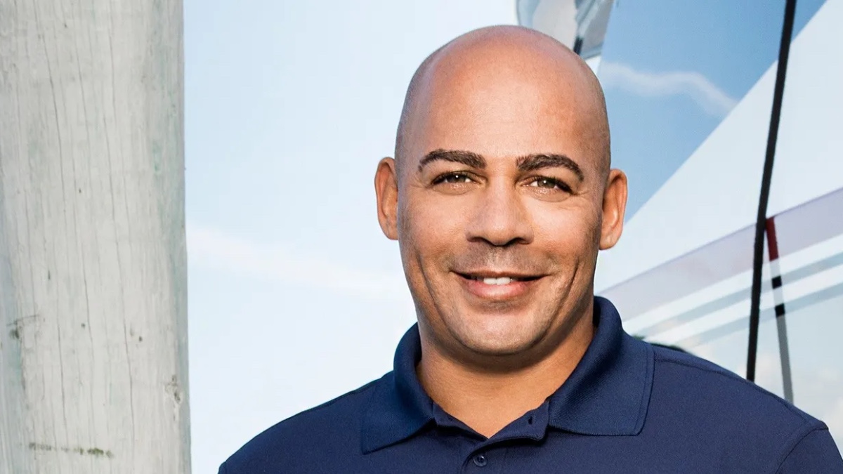 Leon Walker smiling in navy polo shirt