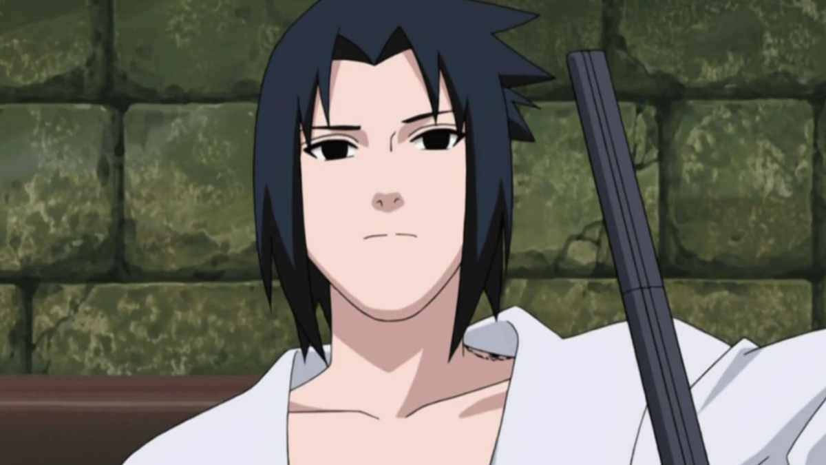 Sasuke is wearing a white shirt and standing in front of a green wall.