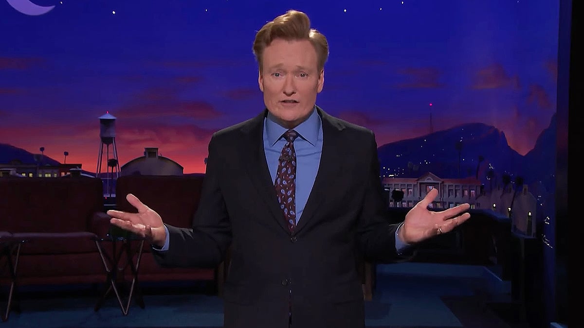 Conan O'Brien gives a shrug while telling a joke on the TBS show 'Conan.'