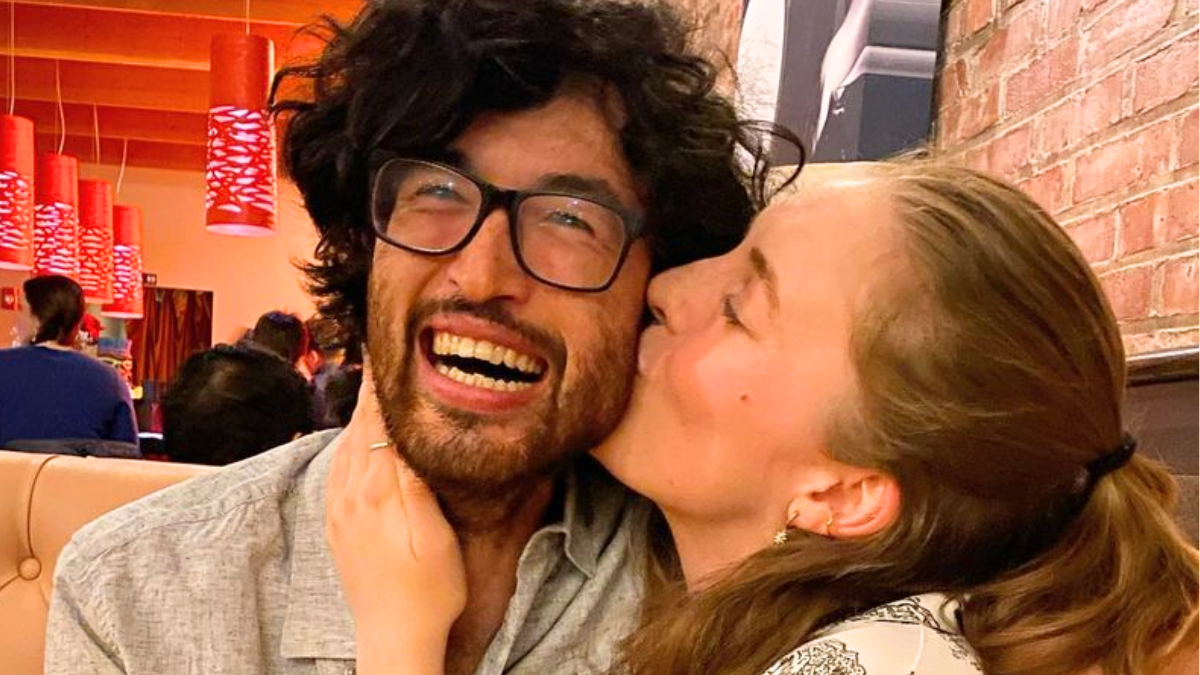 Matt Blankship is seen smiling while Frannie Marin kisses him on the cheek. The pair is seemingly sitting at a restaurant.