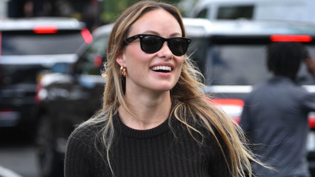 Olivia Wilde out in public smiling and wearing black sunglasses