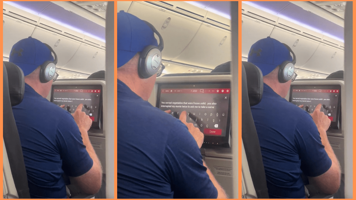 A man types on an in-flight entertainment screen aboard an airplane.