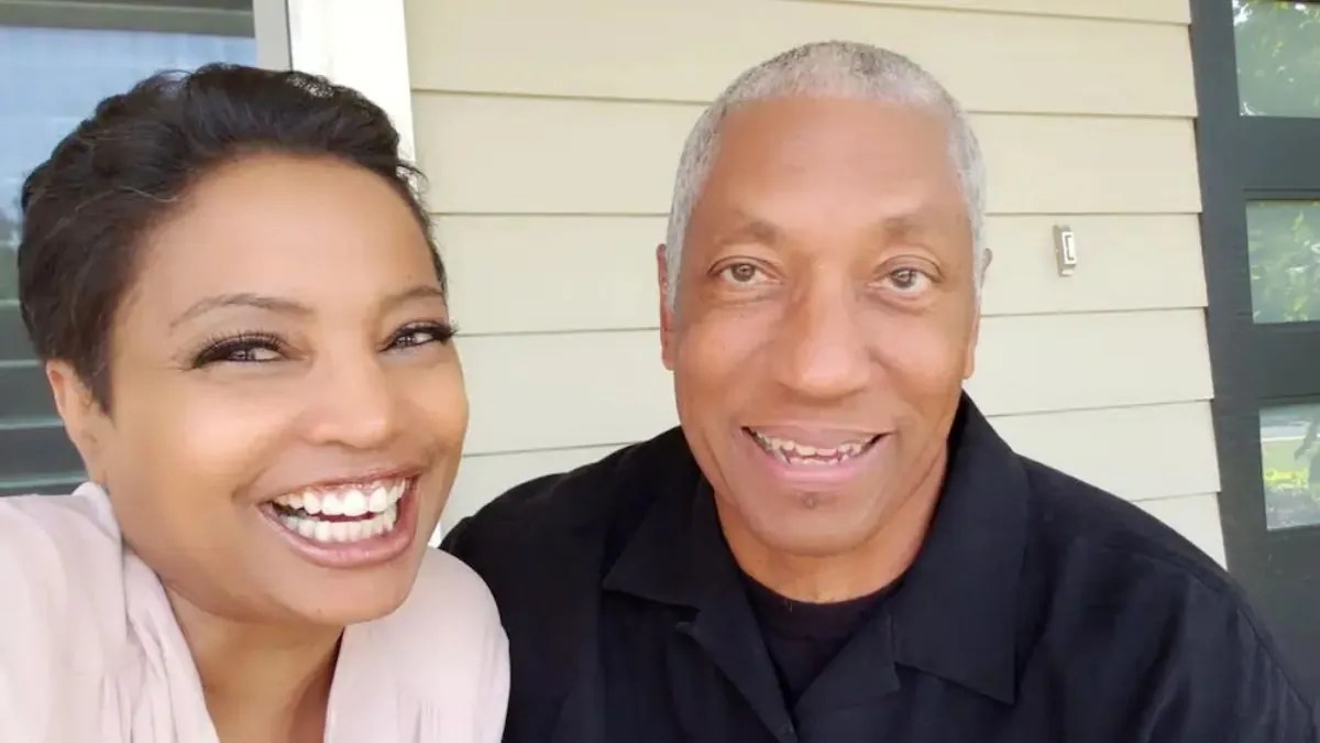 Judge Toler and her husband Eric Mumford posing in front of their home