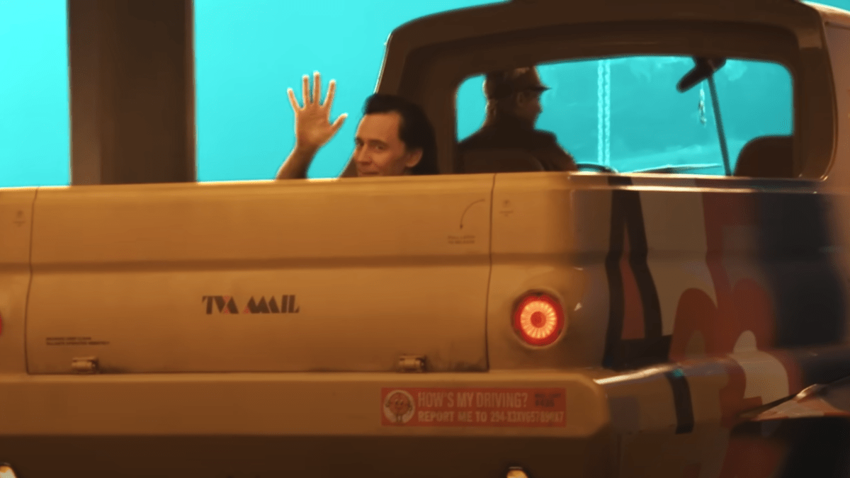 Tom Hiddleston waves from inside the back of a truck in a behind-the-scenes shot from 'Loki' season 2