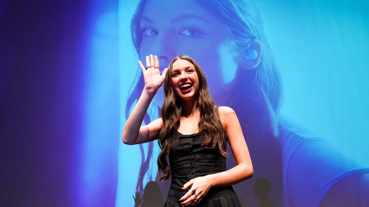 Olivia Rodrigo waves to a crowd at a recent event.