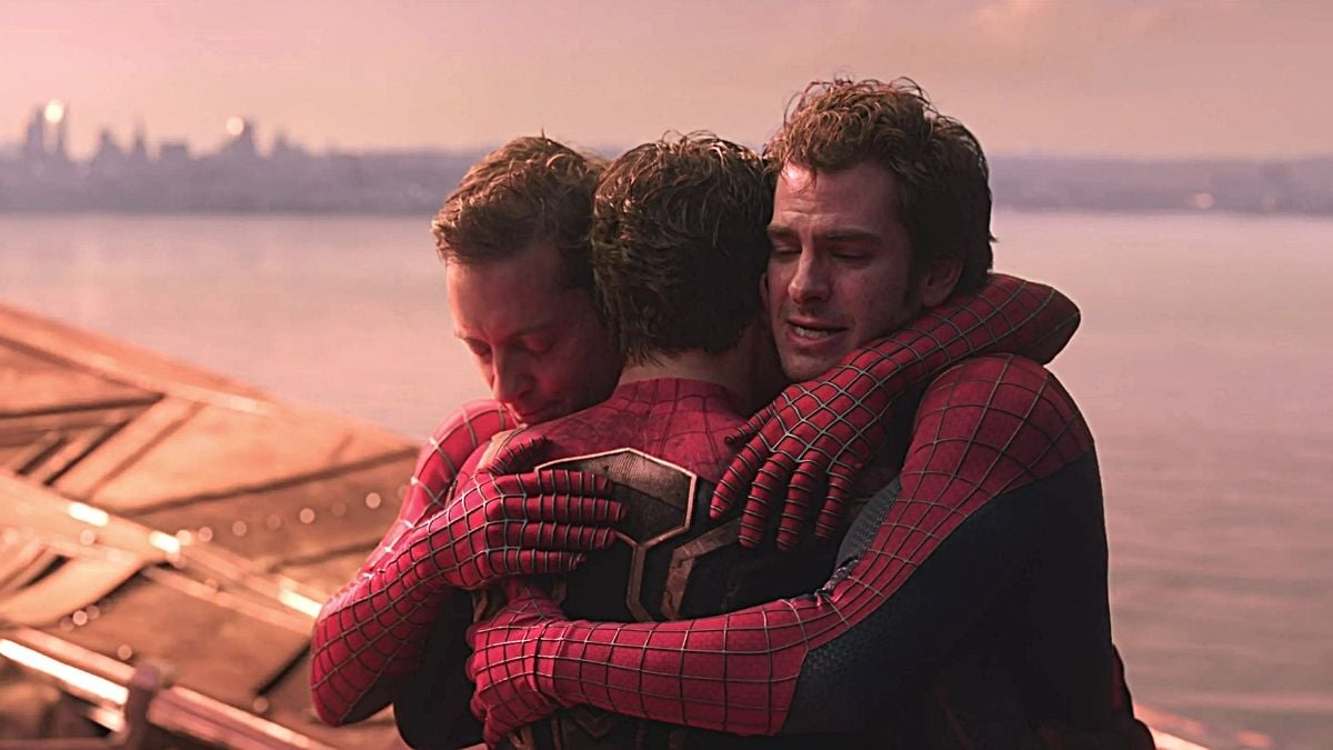 Peter 2 (L), Peter 1 (C), and Peter 3 (R) hug it out in Marvel Studios' 'Spider-Man: No Way Home'.