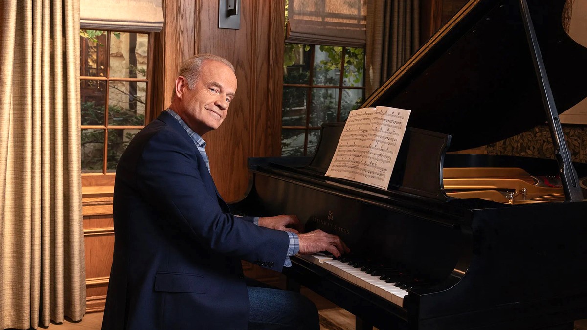 Kelsey Grammer poses by the piano in a promo photo for the 'Frasier' reboot. 