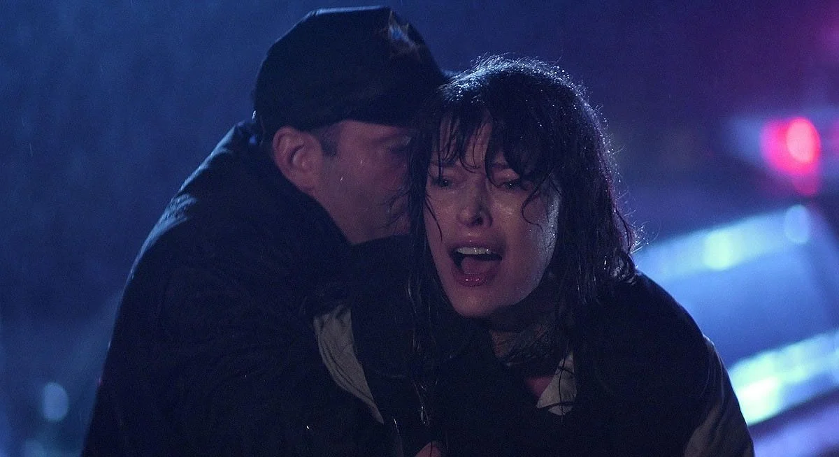 Two characters are caught in the rain in The Fourth Kind.