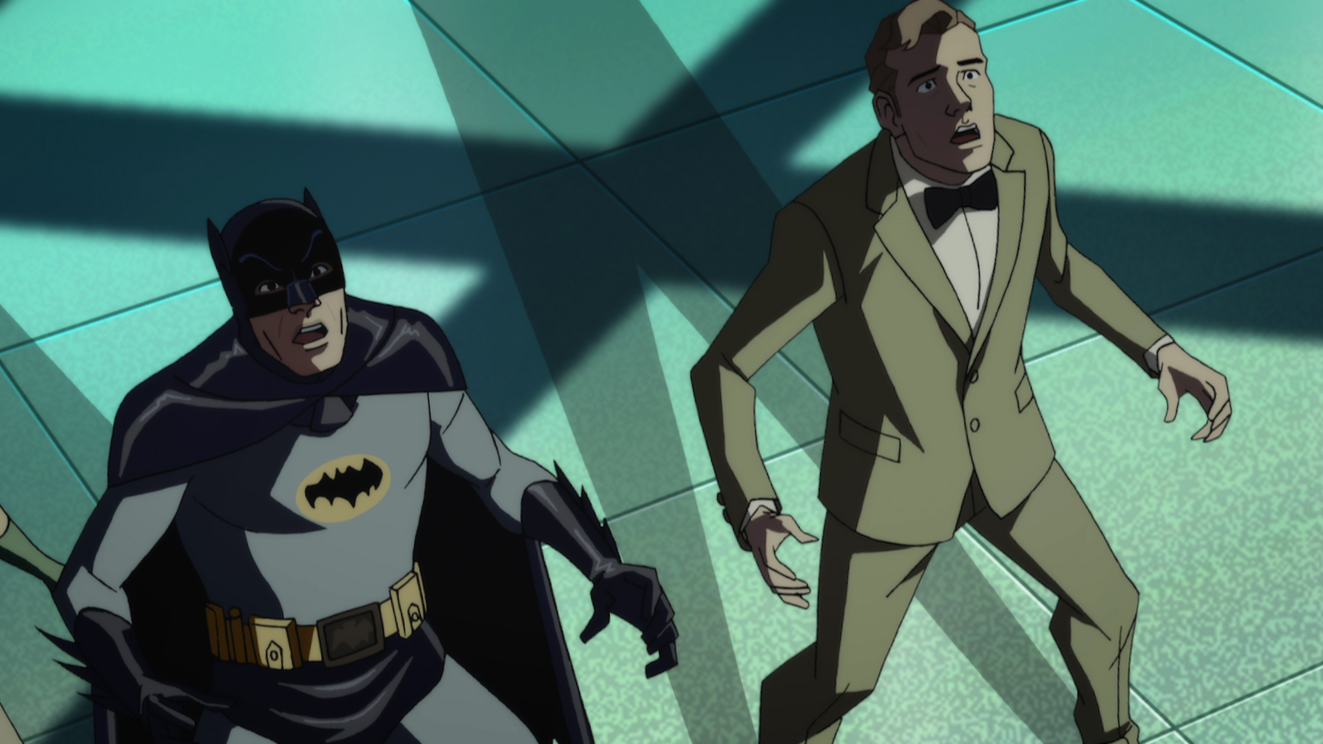 Batman and a man in a suit look shocked. 